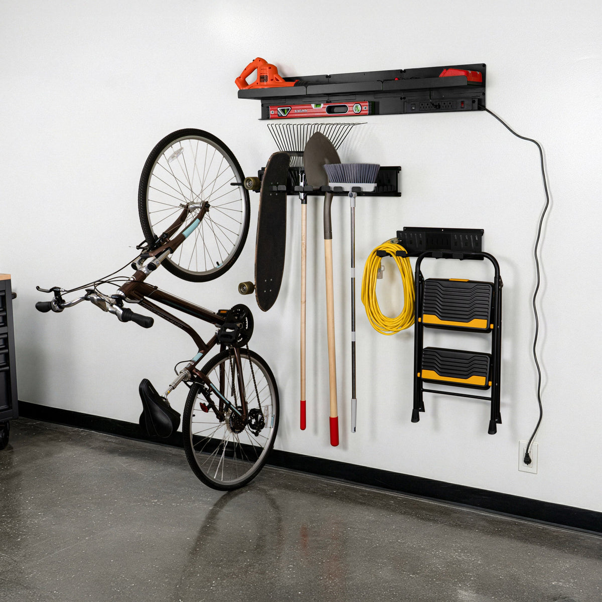 Permasteel 14-Piece Wall Storage System storing a bicycle, ladder, and yard tools