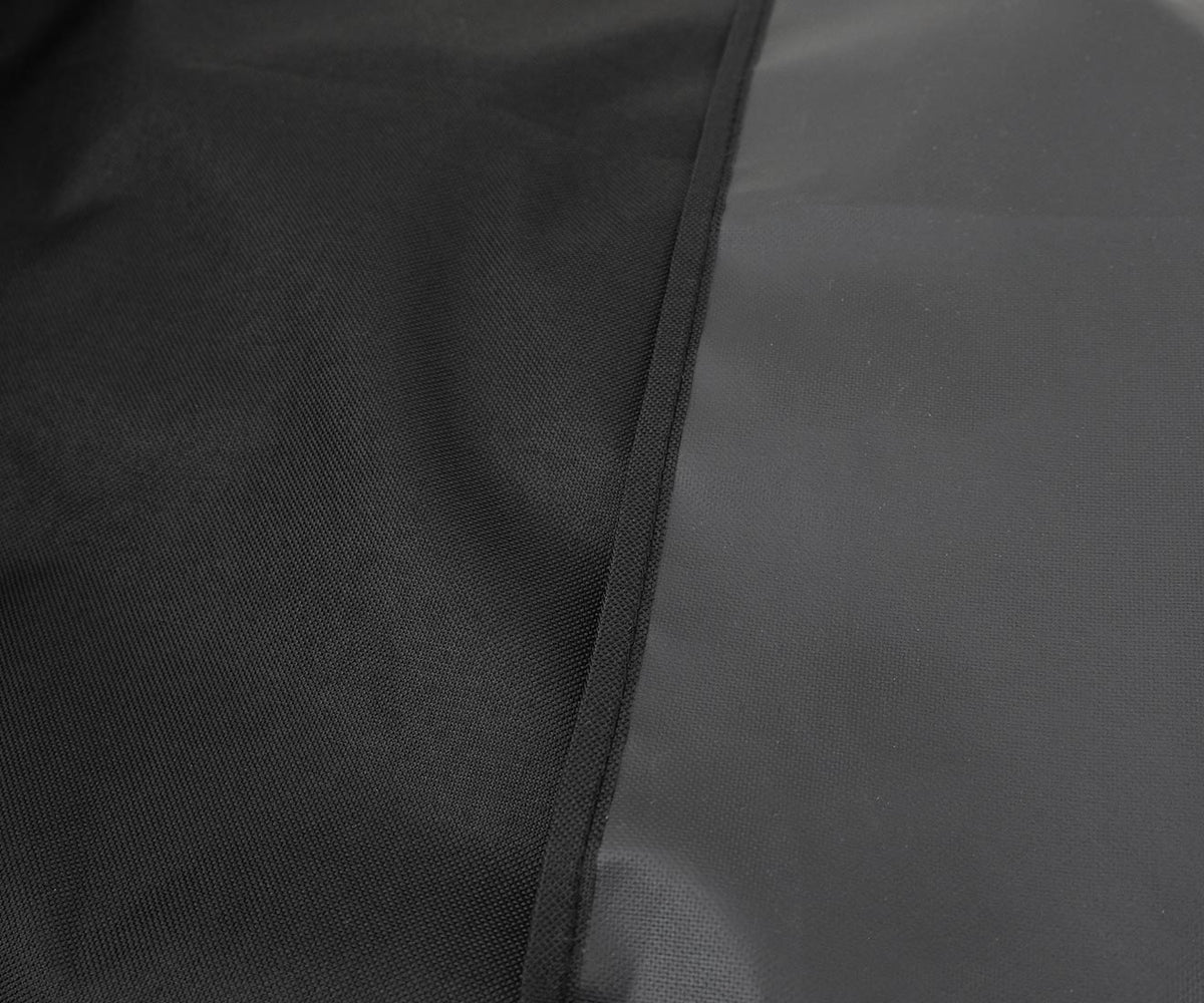 Kenmore 56-inch grill cover, black, close-up of a stitched seam joining black fabric and a smooth gray surface