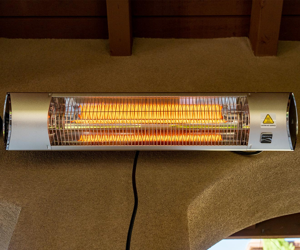 Kenmore wall-mounted electric heater installed under a covered patio ceiling, heating element on